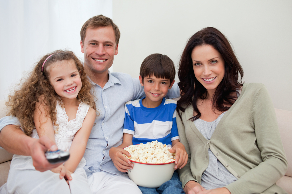 Young family watching a movie together