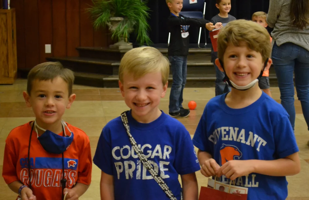 three young boy students smiling in covenant spirit wear
