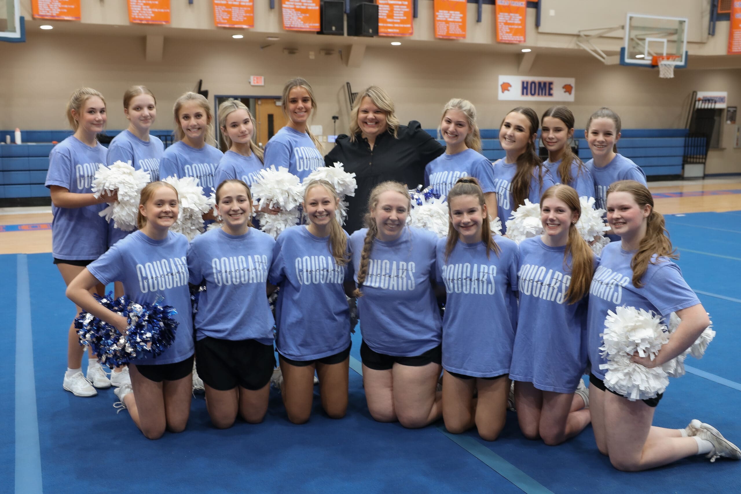 head of school with cheerleaders