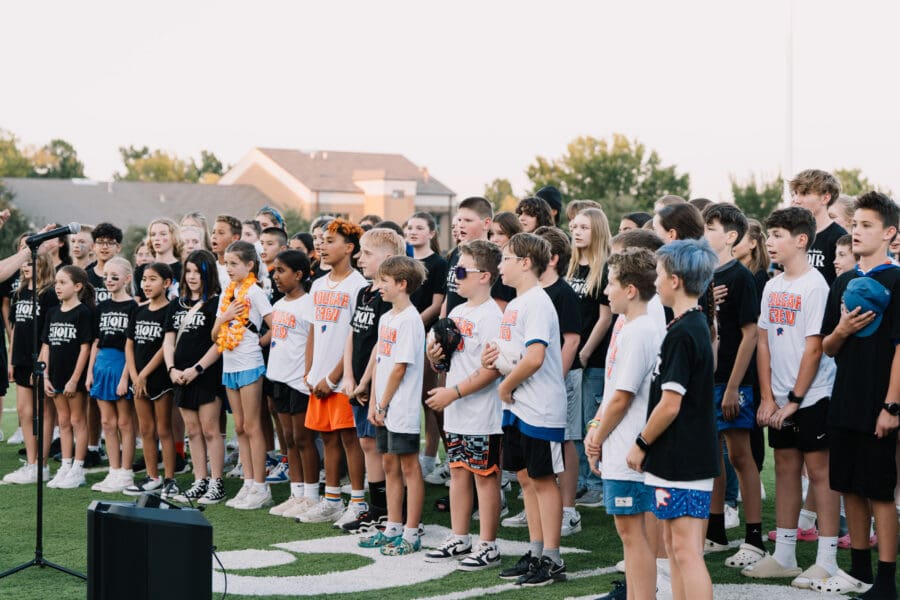 choir singing athem at football game