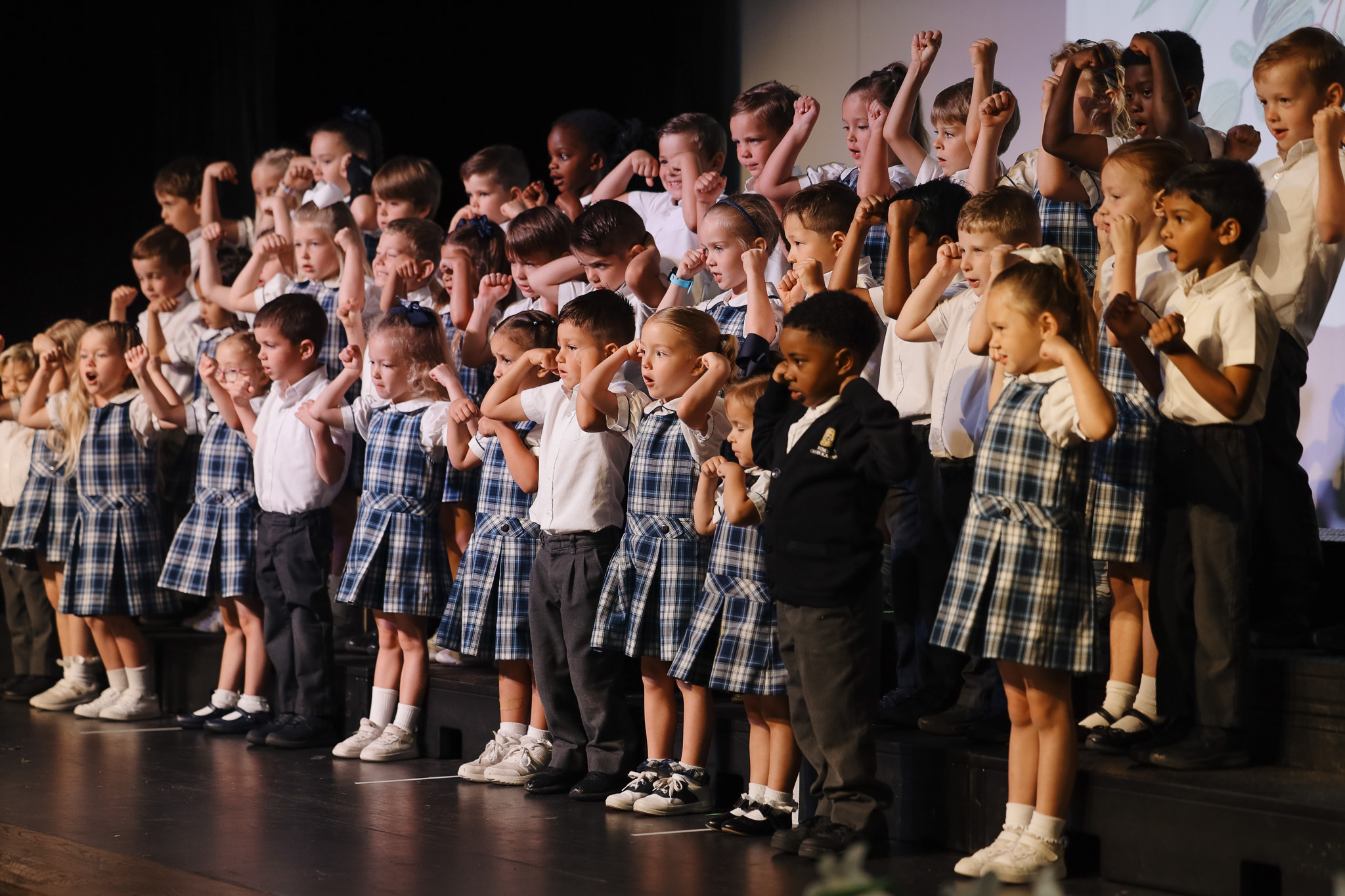 elementary school students petting a goat in the garden